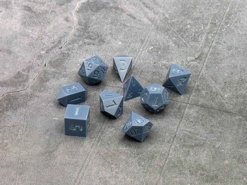 Gray polyhedral dice masters with recessed numbers and three different D4 shapes